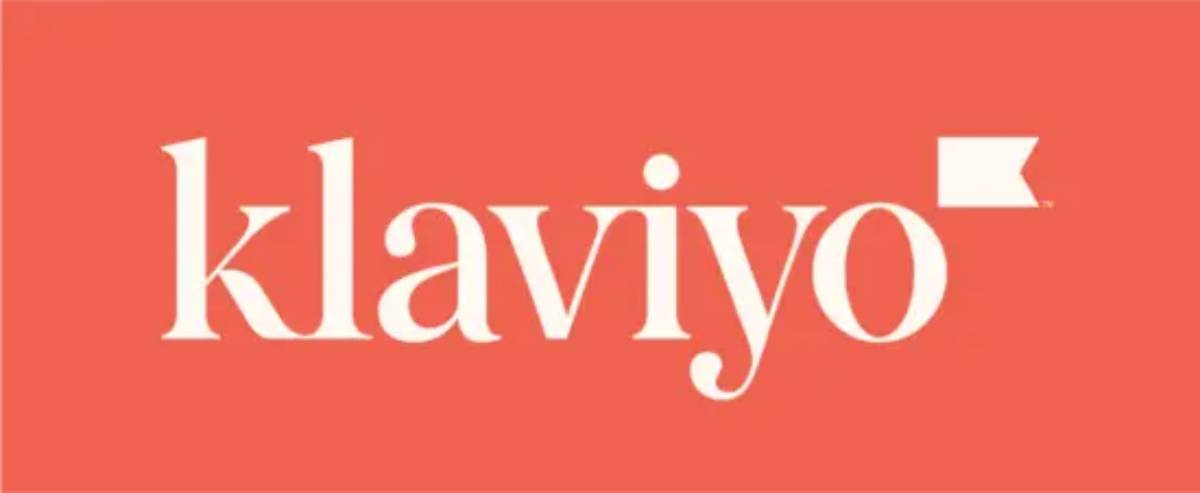Logo of Klaviyo, a marketing automation platform, displayed on a coral background. The font is elegant and modern.