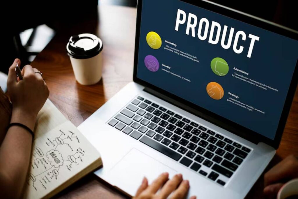 A laptop displays a product overview with sections on Marketing, Identity, Advertising, and Strategy, alongside a coffee cup and notebook.