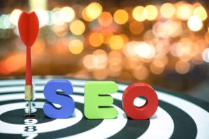 A dart stuck in the bullseye of a target with colorful letters SEO beside it, set against a blurred, vibrant background.