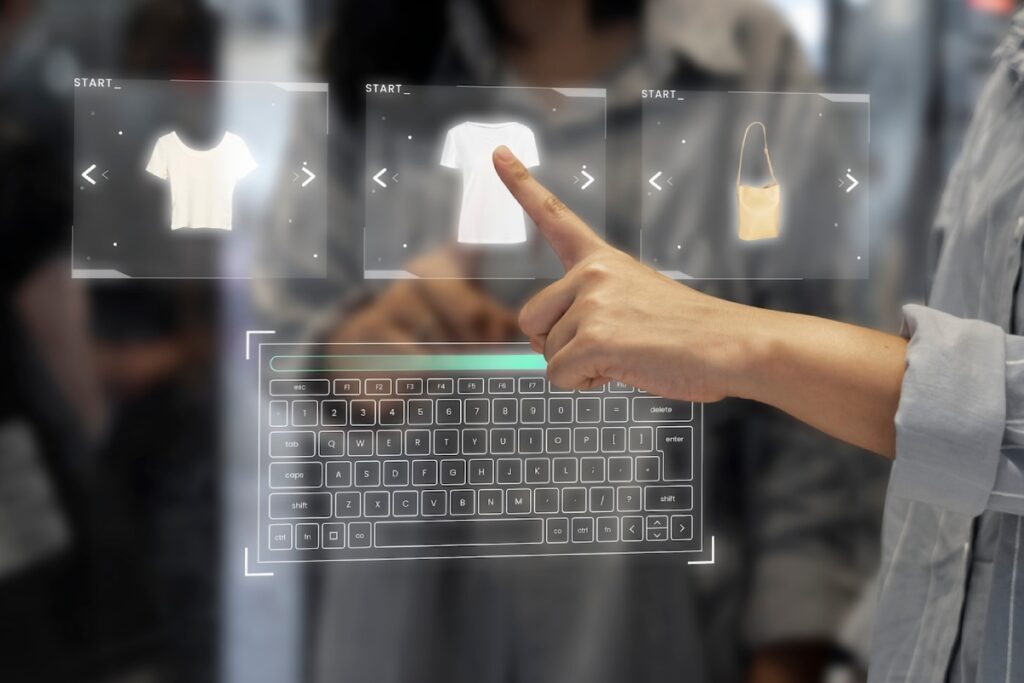 A person interacts with a virtual display, selecting clothing items and accessories, with a digital keyboard visible below.
